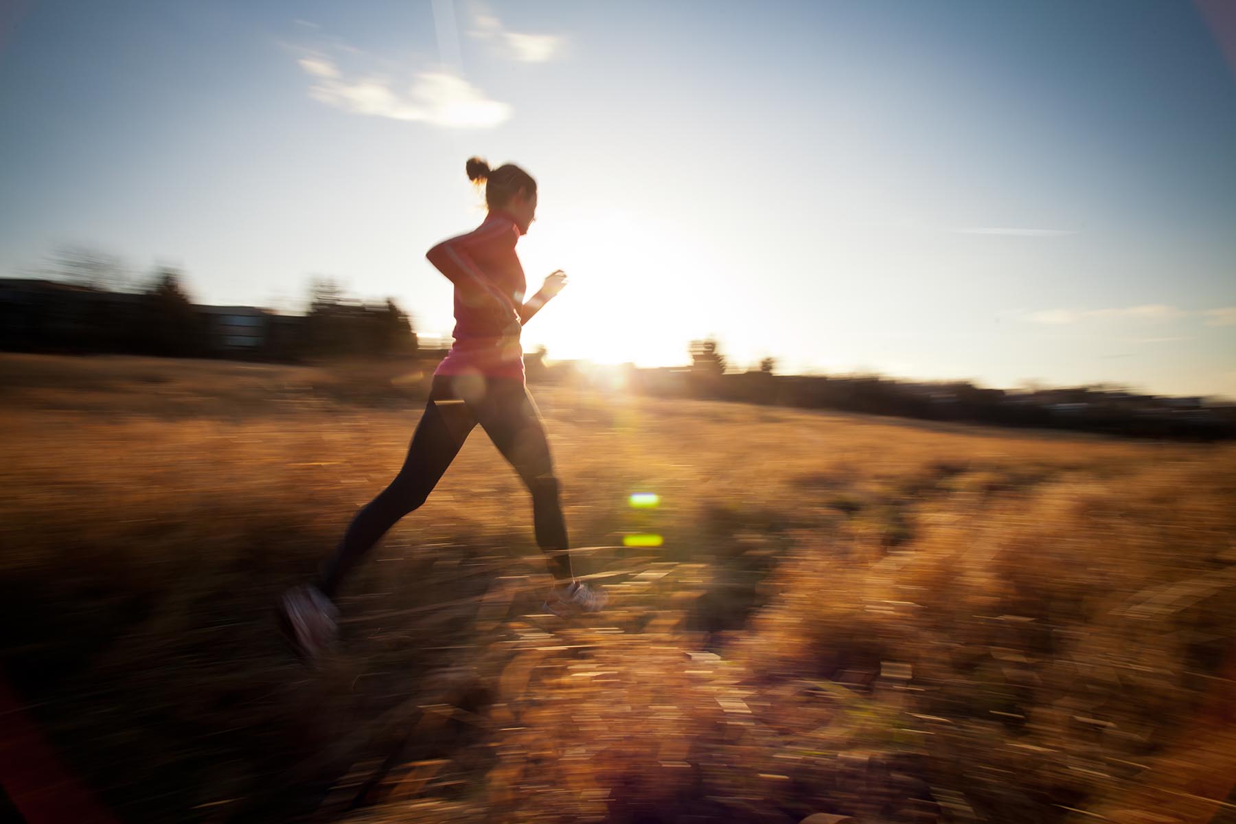 Young Woman Running Outdoors On A Lovely Sunny Winter/fall Day (